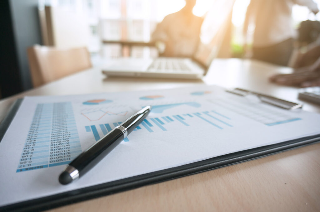 Financial graph with a pen on table in office. business concept